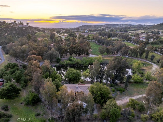 aerial view at dusk featuring a mountain view