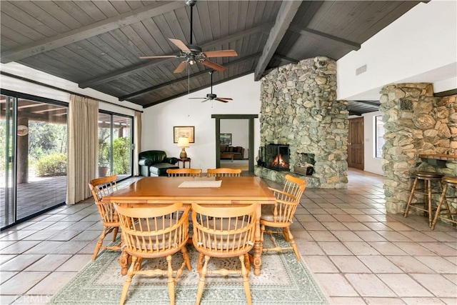 dining room with a ceiling fan, light tile patterned floors, a fireplace, and wooden ceiling
