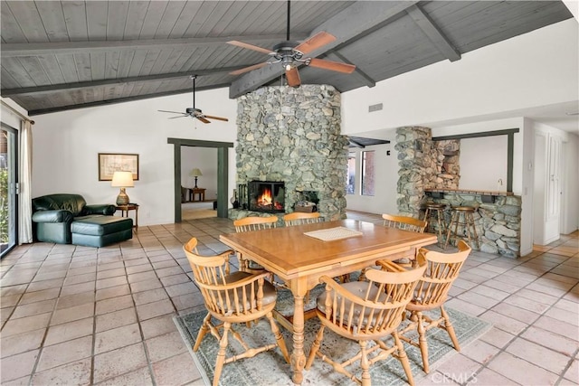 dining room with wooden ceiling, a fireplace, and beam ceiling