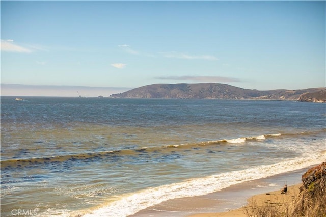 view of water feature featuring a beach view and a mountain view