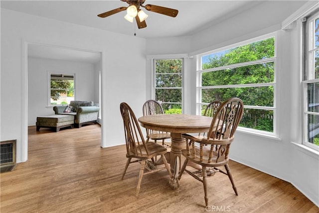 dining room with visible vents, a wealth of natural light, and light wood-style flooring