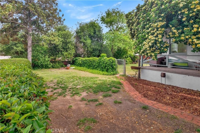 view of yard featuring fence and a gate
