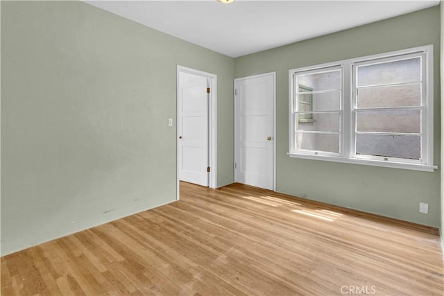 spare room featuring light wood-style flooring