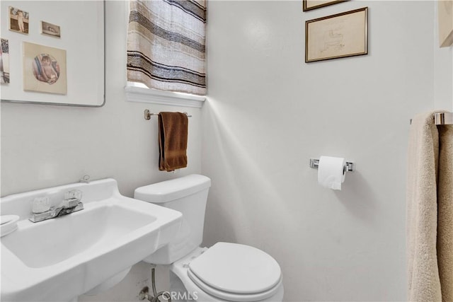 half bathroom with a sink and toilet