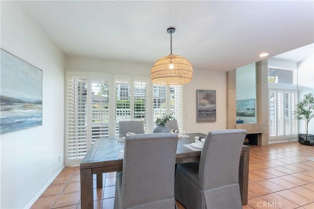 dining area with baseboards and light tile patterned flooring