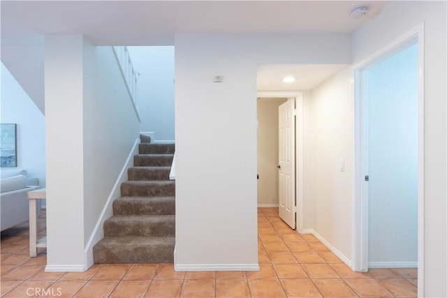stairs featuring tile patterned flooring, recessed lighting, and baseboards