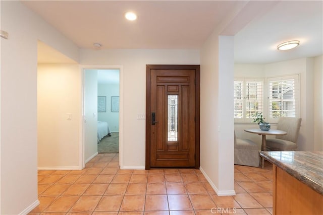 foyer entrance featuring baseboards, recessed lighting, and light tile patterned flooring