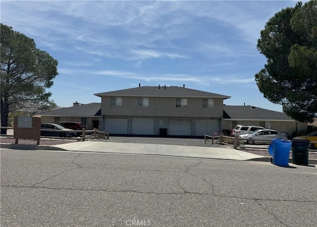 view of front of property featuring concrete driveway and a garage