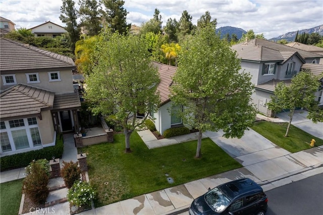 31937 Calle Galarza, Temecula, CA 92592 - view of front of home featuring stucco siding, a tile roof, a front lawn, a mountain view, and concrete driveway