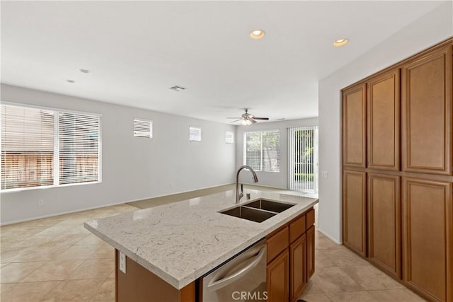 31937 Calle Galarza, Temecula, CA 92592 - kitchen with a sink, stainless steel dishwasher, brown cabinetry, light tile patterned flooring, and a kitchen island with sink