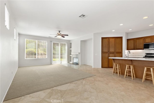 31937 Calle Galarza, Temecula, CA 92592 - living room with a ceiling fan, recessed lighting, light tile patterned floors, and a tiled fireplace