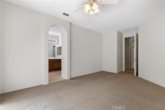 31937 Calle Galarza, Temecula, CA 92592 - spare room featuring light colored carpet, a ceiling fan, arched walkways, and baseboards