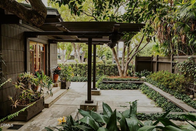 view of patio / terrace featuring a pergola and fence