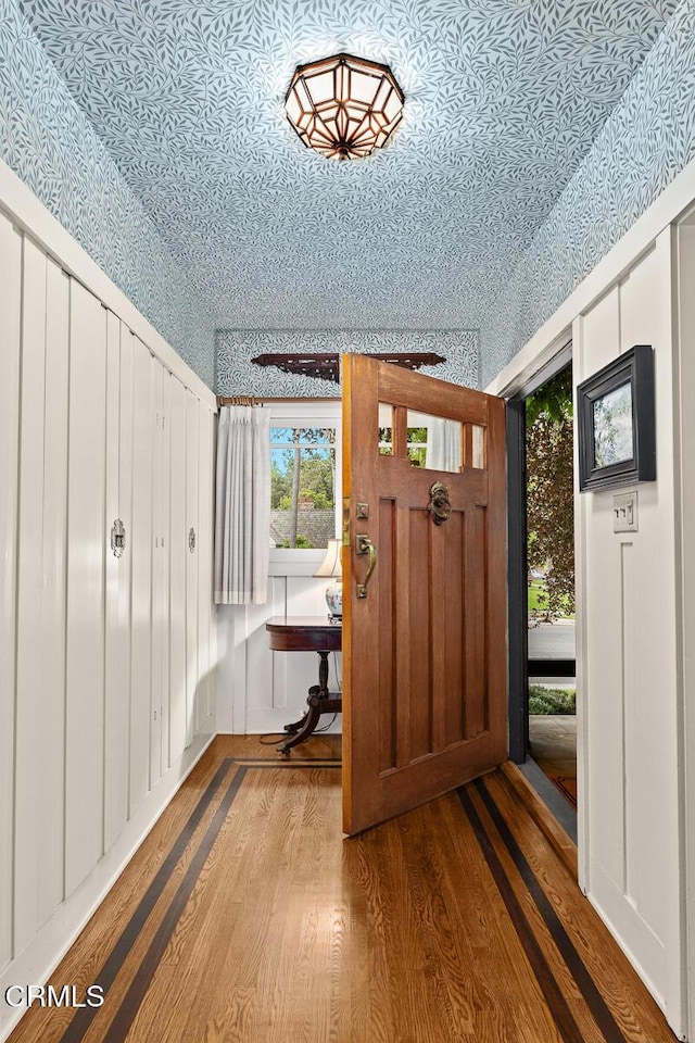 entrance foyer with an ornate ceiling and wood finished floors