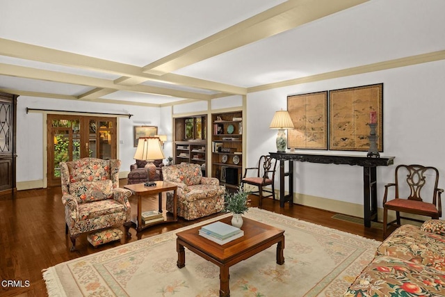 living room featuring baseboards, coffered ceiling, wood finished floors, and beam ceiling