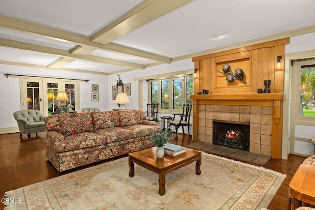 living area with beam ceiling, a fireplace, french doors, wood finished floors, and coffered ceiling