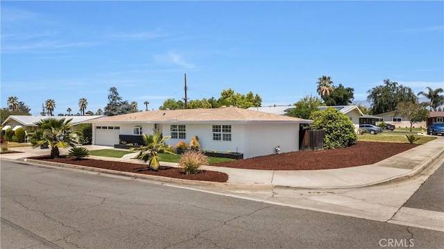 ranch-style home featuring a garage and concrete driveway