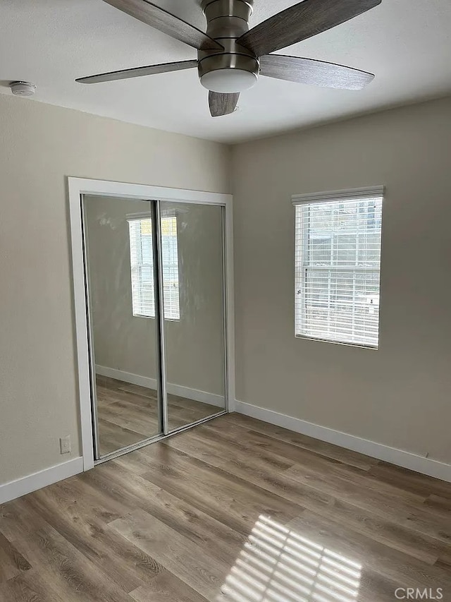 1861 S Redondo Blvd, Los Angeles, CA 90019 - unfurnished bedroom with multiple windows, a closet, and wood finished floors