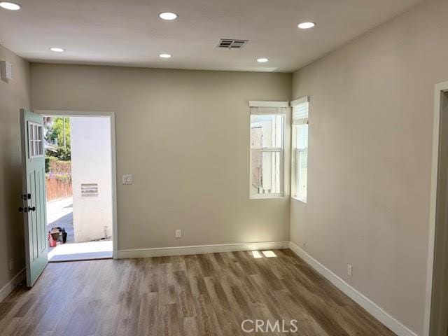 1861 S Redondo Blvd, Los Angeles, CA 90019 - spare room featuring recessed lighting, baseboards, visible vents, and wood finished floors