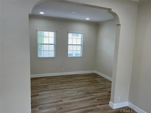 1861 S Redondo Blvd, Los Angeles, CA 90019 - unfurnished room featuring baseboards, arched walkways, wood finished floors, and recessed lighting