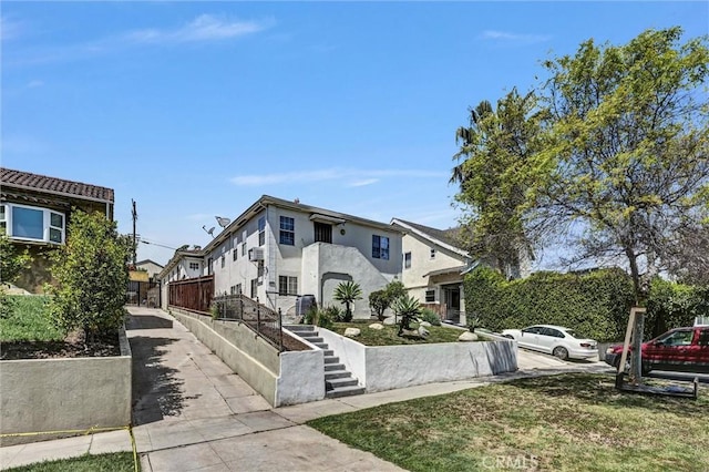 1861 S Redondo Blvd, Los Angeles, CA 90019 - view of front of property with stairs and stucco siding