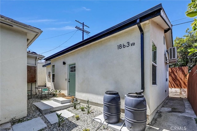 1861 S Redondo Blvd, Los Angeles, CA 90019 - rear view of house with stucco siding and fence
