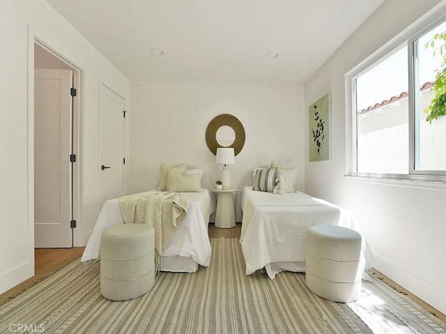 bedroom with baseboards, recessed lighting, and multiple windows