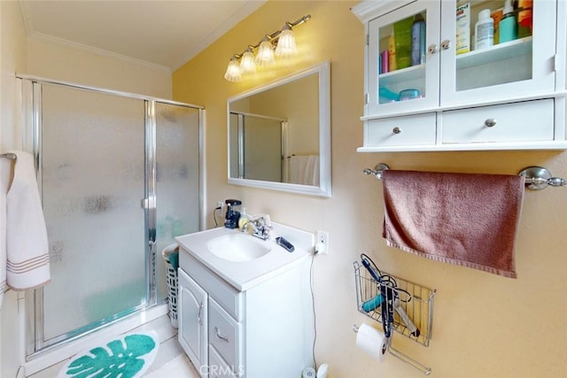 bathroom with crown molding, vanity, and a shower stall