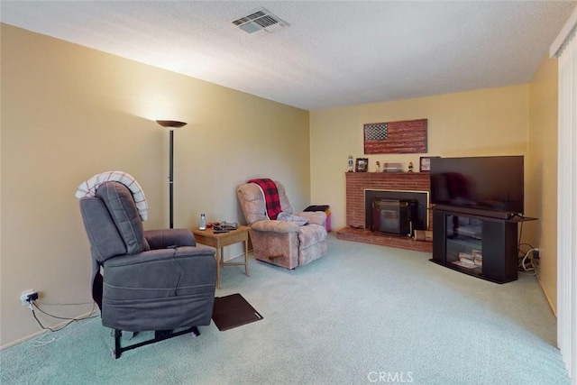 living area featuring carpet flooring, visible vents, and a fireplace