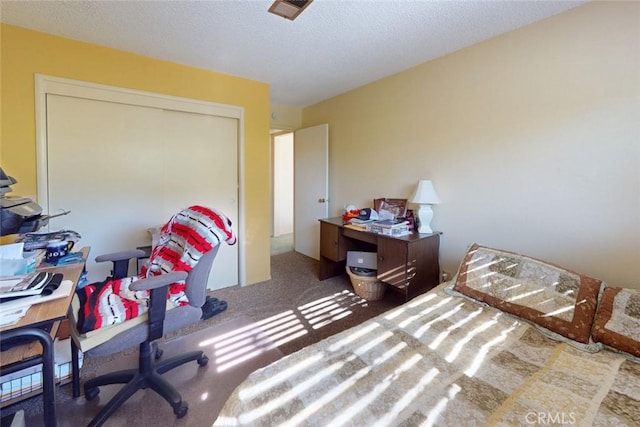 carpeted bedroom with a textured ceiling