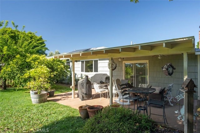 rear view of house with a patio area and a yard
