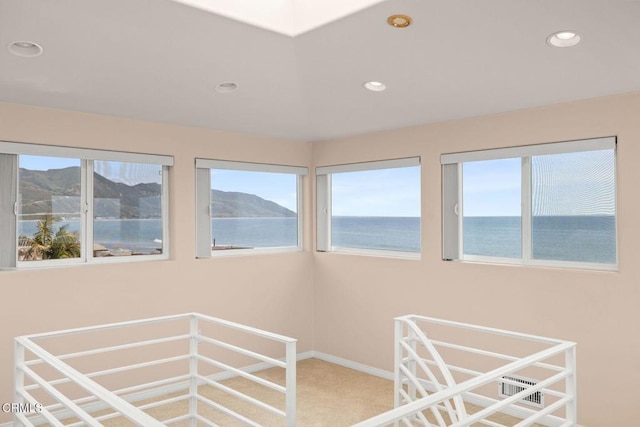 unfurnished sunroom with a water view and a wealth of natural light