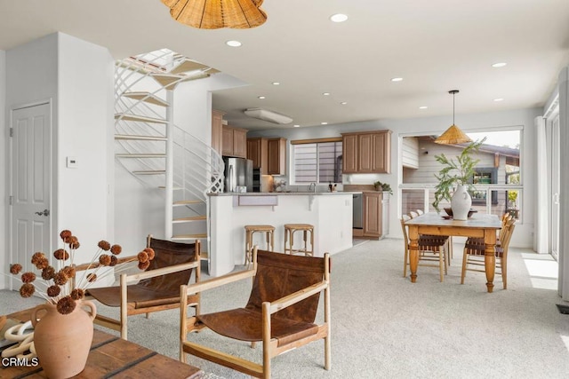 dining area featuring light colored carpet and recessed lighting