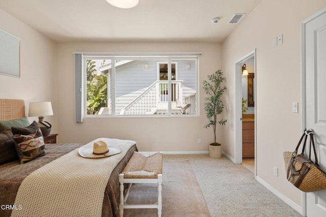 bedroom with baseboards, visible vents, and carpet