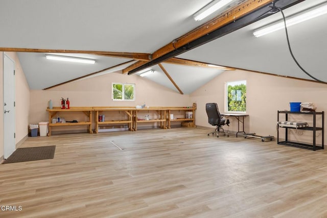 additional living space featuring lofted ceiling with beams and wood finished floors