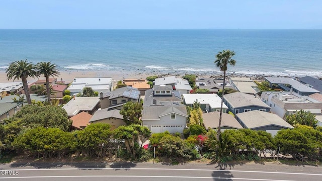 bird's eye view featuring a beach view, a water view, and a residential view