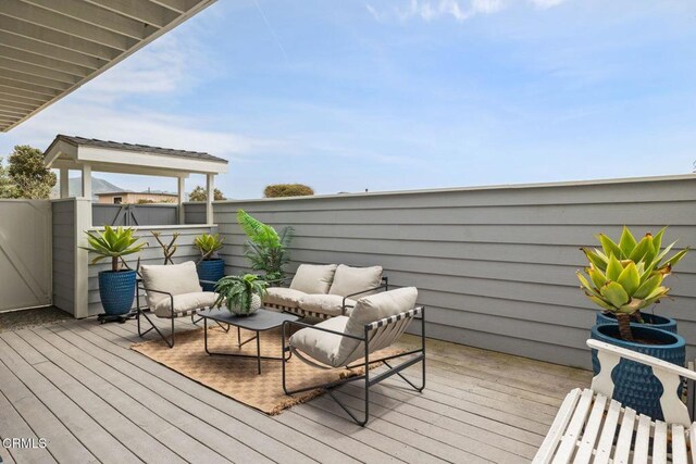 wooden deck featuring an outdoor living space