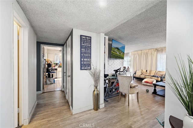 10139 Hayvenhurst Ave, North Hills, CA 91343 - corridor featuring a textured ceiling, baseboards, and wood finished floors