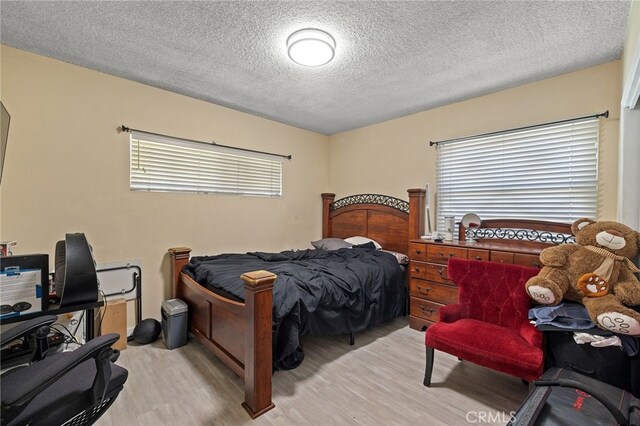 10139 Hayvenhurst Ave, North Hills, CA 91343 - bedroom with wood finished floors and a textured ceiling