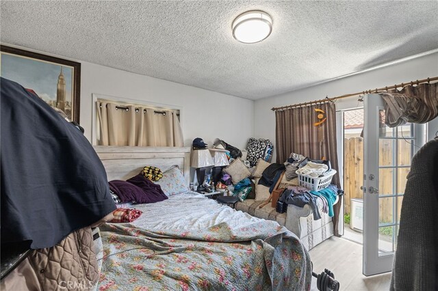 10139 Hayvenhurst Ave, North Hills, CA 91343 - bedroom featuring a textured ceiling and wood finished floors