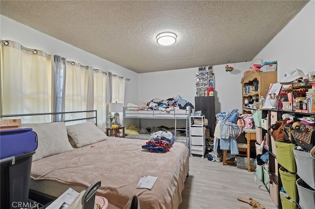 10139 Hayvenhurst Ave, North Hills, CA 91343 - bedroom with a textured ceiling and wood finished floors