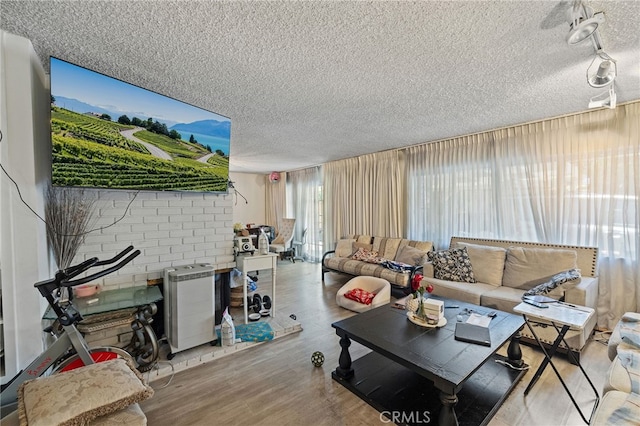 10139 Hayvenhurst Ave, North Hills, CA 91343 - living room with a textured ceiling, wood finished floors, and track lighting