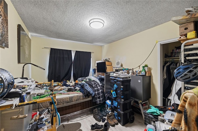 10139 Hayvenhurst Ave, North Hills, CA 91343 - bedroom featuring a textured ceiling, wood finished floors, and a closet
