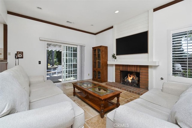 living area featuring visible vents, ornamental molding, a fireplace, recessed lighting, and stone finish flooring