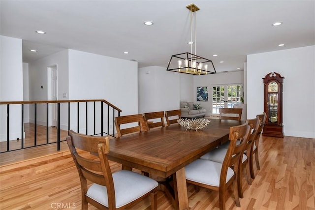 dining area featuring recessed lighting, baseboards, an inviting chandelier, and light wood-type flooring