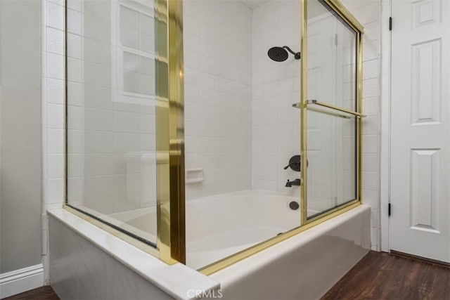 full bathroom with wood finished floors and shower / bath combination with glass door