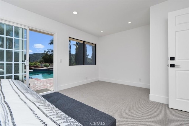 unfurnished bedroom featuring recessed lighting, carpet flooring, and baseboards