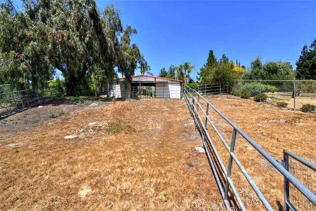 view of yard featuring an outbuilding and an exterior structure