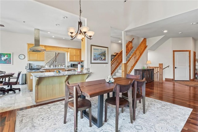 1305 Montreal Dr, Lake Arrowhead, CA 92352 - dining area with an inviting chandelier, recessed lighting, light wood-style flooring, and stairway