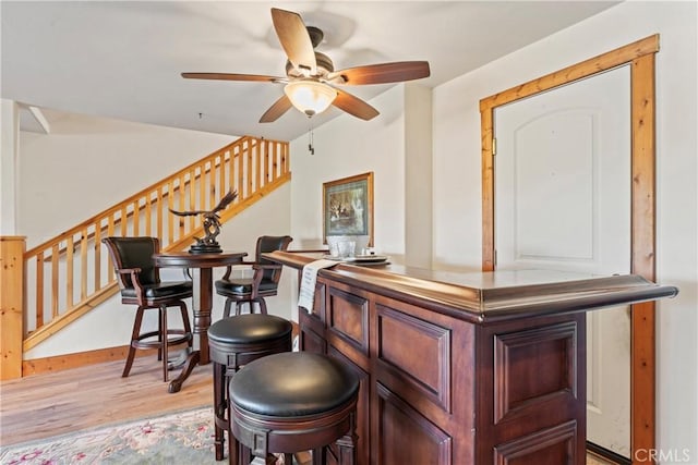 1305 Montreal Dr, Lake Arrowhead, CA 92352 - bar with stairs, ceiling fan, baseboards, and light wood finished floors